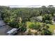 Stunning aerial shot of the property featuring a private dock and landscaped yard at 1949 Bayview Dr, New Smyrna Beach, FL 32168