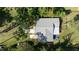 Aerial shot of a home highlighting the roof, patio, and surrounding greenery in a peaceful, natural setting at 1949 Bayview Dr, New Smyrna Beach, FL 32168