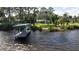 The rear of the house and the private dock with a boat cover at 1949 Bayview Dr, New Smyrna Beach, FL 32168