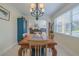 Charming dining room featuring a wooden table, chandelier, and ample natural light at 1949 Bayview Dr, New Smyrna Beach, FL 32168