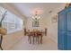 This dining room features a chandelier and a large window for natural light at 1949 Bayview Dr, New Smyrna Beach, FL 32168