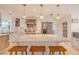 Bright kitchen features a marble top island, stainless steel appliances, and colorful pendant lighting at 1949 Bayview Dr, New Smyrna Beach, FL 32168