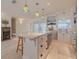 Elegant kitchen with a marble island, modern appliances, and stylish pendant lights at 1949 Bayview Dr, New Smyrna Beach, FL 32168