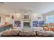 Inviting living room with a decorative fireplace, custom shelving, and comfortable seating arrangement at 1949 Bayview Dr, New Smyrna Beach, FL 32168