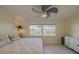 Relaxing main bedroom with a ceiling fan and a scenic view of the water at 1949 Bayview Dr, New Smyrna Beach, FL 32168