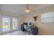 Office area with a desk, dual monitors and a sliding door to the backyard at 1949 Bayview Dr, New Smyrna Beach, FL 32168