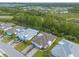 Overhead view displays a row of well-maintained houses with neat lawns, nestled in a peaceful neighborhood with a lake at 306 Coral Reef Way, Daytona Beach, FL 32124