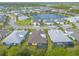 Scenic aerial view of a residential neighborhood surrounding a tranquil lake at 306 Coral Reef Way, Daytona Beach, FL 32124