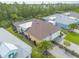 Aerial view of a home with a well-maintained yard, pool, and brick paver driveway at 306 Coral Reef Way, Daytona Beach, FL 32124