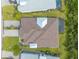 Overhead view of a home featuring a pristine roof, paver driveway, and lush landscaping at 306 Coral Reef Way, Daytona Beach, FL 32124