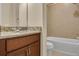 Bathroom boasts granite counters, wood cabinets, and tiled shower at 306 Coral Reef Way, Daytona Beach, FL 32124