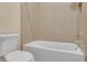 Bathroom featuring a tub with shower and a toilet at 306 Coral Reef Way, Daytona Beach, FL 32124