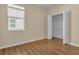 Bright bedroom featuring hardwood floors, closet, and a window with natural light at 306 Coral Reef Way, Daytona Beach, FL 32124