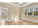 Sunlit bedroom features hardwood floors, a large window, and ensuite bathroom access at 306 Coral Reef Way, Daytona Beach, FL 32124
