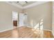 Bright bedroom features hardwood floors, tray ceilings, and ensuite bathroom access at 306 Coral Reef Way, Daytona Beach, FL 32124
