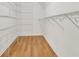 Organized walk-in closet with wire shelving and hardwood floors at 306 Coral Reef Way, Daytona Beach, FL 32124