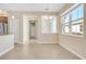 A dining area shows a bright window, tile flooring, and access to kitchen, creating a comfortable space at 306 Coral Reef Way, Daytona Beach, FL 32124