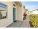 Charming home entrance featuring a bright blue door and a well-manicured walkway at 306 Coral Reef Way, Daytona Beach, FL 32124
