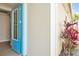 Inviting home entrance featuring a glass-paneled door and lush tropical landscaping at 306 Coral Reef Way, Daytona Beach, FL 32124
