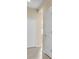 Bright hallway featuring tiled floors and a series of doors, enhancing the home's functionality at 306 Coral Reef Way, Daytona Beach, FL 32124