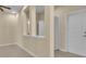 Bright hallway features neutral paint and a series of doors, adding depth and functionality at 306 Coral Reef Way, Daytona Beach, FL 32124