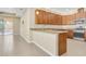 Open kitchen features granite counters, wood cabinets, stainless steel appliances, and tiled flooring, creating a modern and inviting space at 306 Coral Reef Way, Daytona Beach, FL 32124