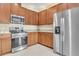 Clean kitchen with stainless steel appliances and brown wood cabinets at 306 Coral Reef Way, Daytona Beach, FL 32124