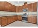 Spacious kitchen boasts stainless steel appliances, granite counters, and ample cabinet space at 306 Coral Reef Way, Daytona Beach, FL 32124