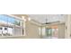 A bright room features large windows and a ceiling fan, providing ample natural light and ventilation at 306 Coral Reef Way, Daytona Beach, FL 32124