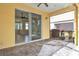 Covered patio featuring brick flooring, a ceiling fan, and sliding door access to the interior at 306 Coral Reef Way, Daytona Beach, FL 32124