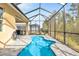 Relaxing screened-in pool with beautiful blue water and spacious brick patio at 306 Coral Reef Way, Daytona Beach, FL 32124
