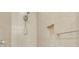 Close up of shower featuring detailed tile work, rainfall showerhead, and built-in shelving at 306 Coral Reef Way, Daytona Beach, FL 32124