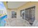 Inviting balcony space furnished with a glass table and chairs, ideal for outdoor dining and relaxing at 5300 S Atlantic Ave # 8-303, New Smyrna Beach, FL 32169