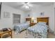 Bright bedroom featuring two twin beds, nautical decor, and a ceiling fan for a comfortable coastal retreat at 5300 S Atlantic Ave # 8-303, New Smyrna Beach, FL 32169