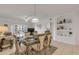 Formal dining area adjacent to living room and well-appointed shelving at 5300 S Atlantic Ave # 8-303, New Smyrna Beach, FL 32169