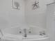 Close-up on a soaking tub with tile surround at 5300 S Atlantic Ave # 8-303, New Smyrna Beach, FL 32169