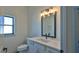 Bathroom with single vanity, toilet, and window at 1428 Willow Oak Dr, Edgewater, FL 32132