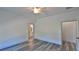 Bright bedroom with wood-look floors and ensuite bathroom at 1428 Willow Oak Dr, Edgewater, FL 32132