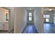 Bright hallway with wood-look flooring and access to rooms at 1428 Willow Oak Dr, Edgewater, FL 32132