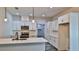 Modern kitchen with white cabinets, island, and stainless steel appliances at 1428 Willow Oak Dr, Edgewater, FL 32132