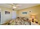 Cozy bedroom featuring tropical-themed bedding, a ceiling fan, and neutral wall paint at 2700 N Peninsula Ave # 322, New Smyrna Beach, FL 32169