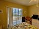 Inviting bedroom with balcony access, natural light, and view to the water at 2700 N Peninsula Ave # 322, New Smyrna Beach, FL 32169