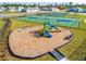 Community playground featuring colorful slides and climbing structures, with basketball and tennis courts nearby at 5226 Hophorn Dr, Edgewater, FL 32141