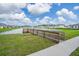 Scenic pond view with a wooden fishing dock adding charm to the community at 5226 Hophorn Dr, Edgewater, FL 32141