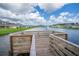 Beautiful pond featuring a fountain and wooden dock offering a tranquil community space at 5226 Hophorn Dr, Edgewater, FL 32141