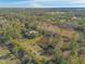 Home surrounded by lush greenery and a pond at 1035 S State Road 415, New Smyrna Beach, FL 32168