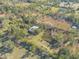 Aerial view of house, pond, and lush vegetation at 1035 S State Road 415, New Smyrna Beach, FL 32168