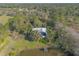 Aerial view of home nestled in trees near pond at 1035 S State Road 415, New Smyrna Beach, FL 32168