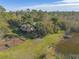 Single-story home on a large lot with a pond at 1035 S State Road 415, New Smyrna Beach, FL 32168