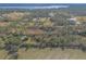 Aerial view showcasing home, pond and rural landscape at 1035 S State Road 415, New Smyrna Beach, FL 32168